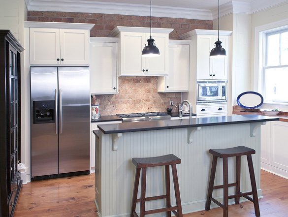 white kitchen with stools at island